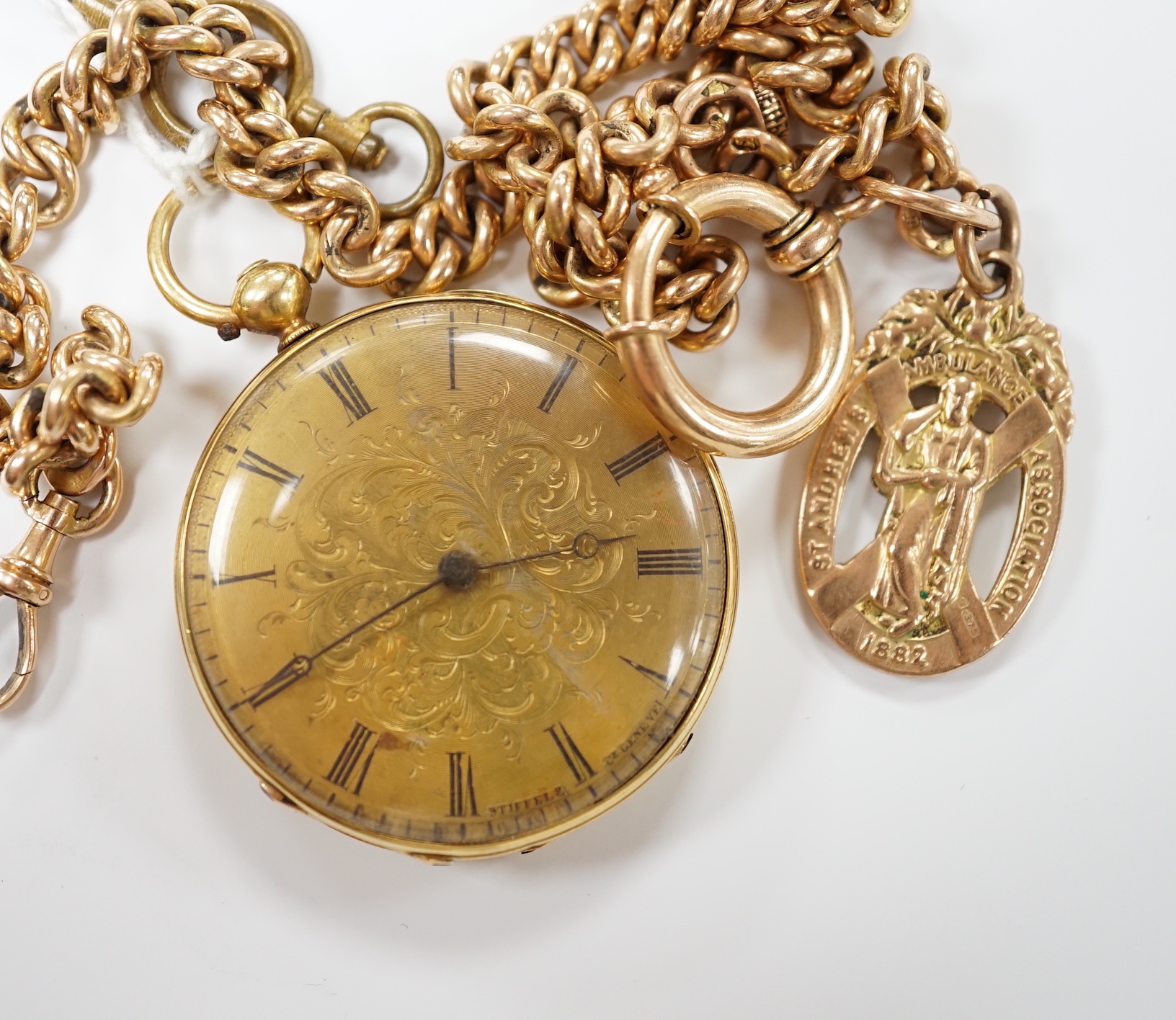 An 18k open face fob watch, with Roman dial, gross weight 38.5 grams, with key, together with a 9ct albert hung with a 9ct gold St. Andres Ambulance Association charm, gross weight 24.2 grams.